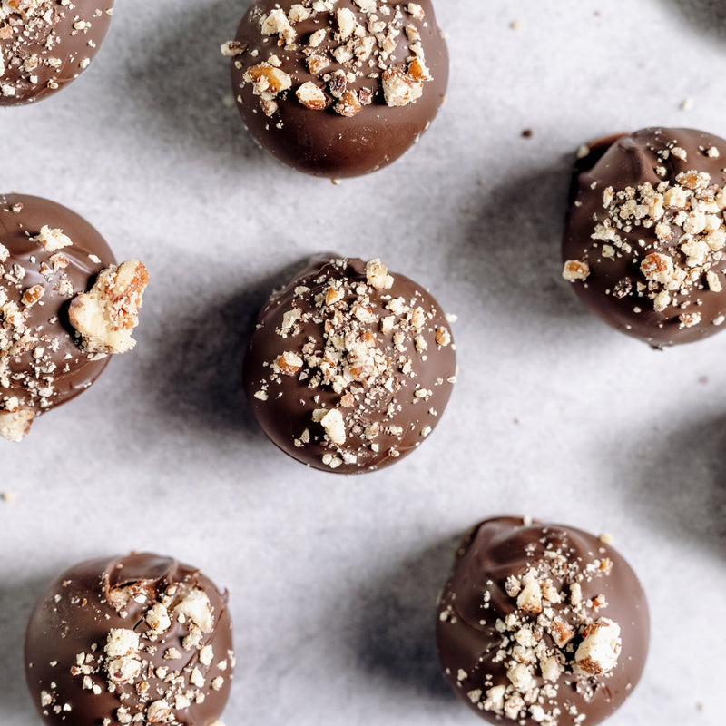 Chocolate truffles with crumb topping on a marble surface