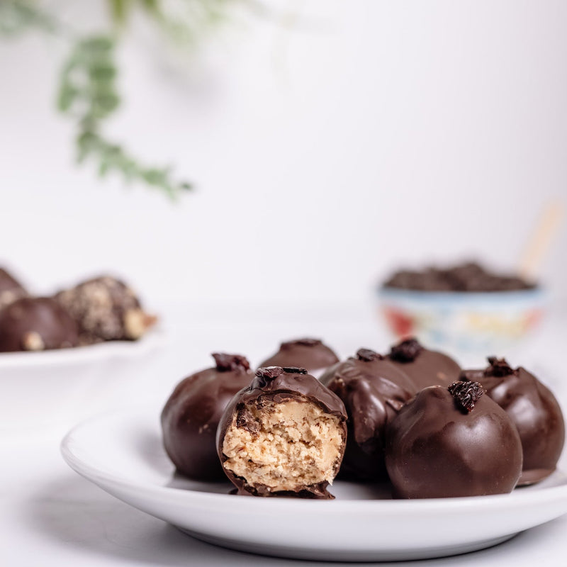 Chocolate-covered treats on a plate with a blurred background
