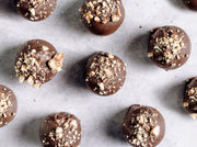 Chocolate truffles with crumb topping on a marble surface