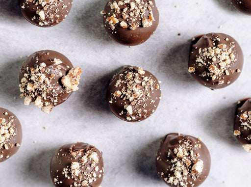Chocolate truffles with crumb topping on a marble surface