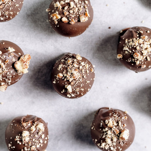 Chocolate truffles with crumb topping on a marble surface