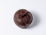 Dark Chocolate Brandy Old Fashioned Truffle on a white background