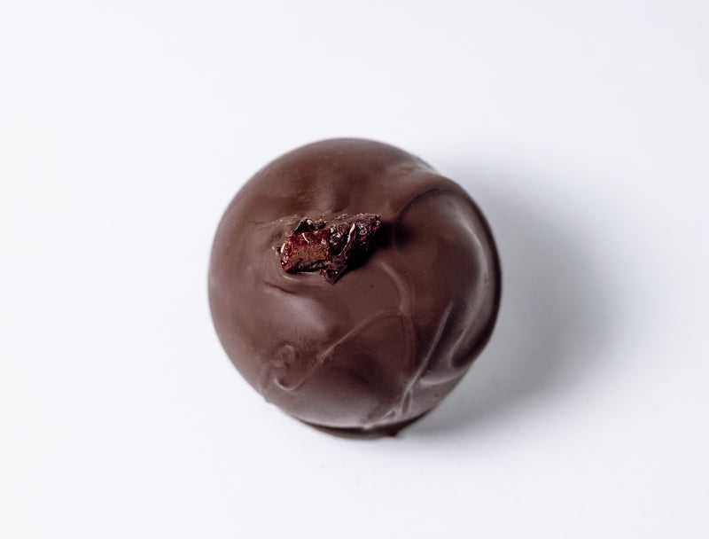 Dark Chocolate Brandy Old Fashioned Truffle on a white background