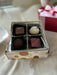 Gift box that includes Sea Salt Caramel, Ruby French Silk, Dark Raspberry and White Violet. 