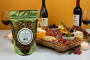 Packaged snack with a charcuterie board and wine on a table